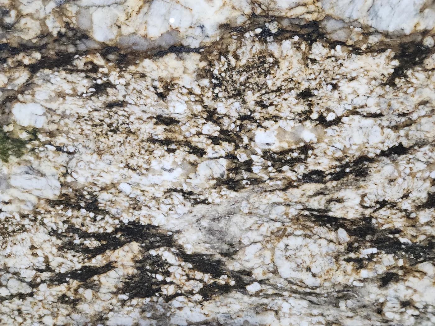 Blue Dunes granite, cream and white crystal shot through with black and gold