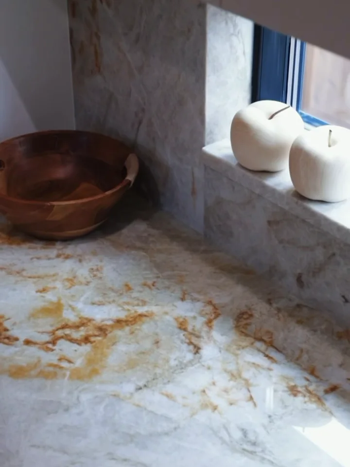 A vessel basin set on a gold-veined stone counter