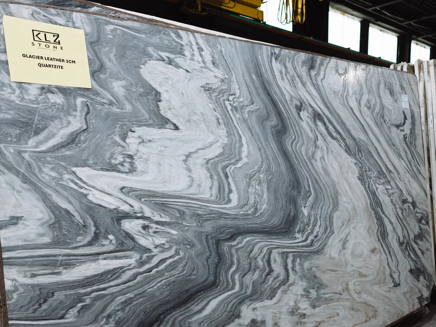 Glacier Leather quartzite, a grey and white slab with flowing movement