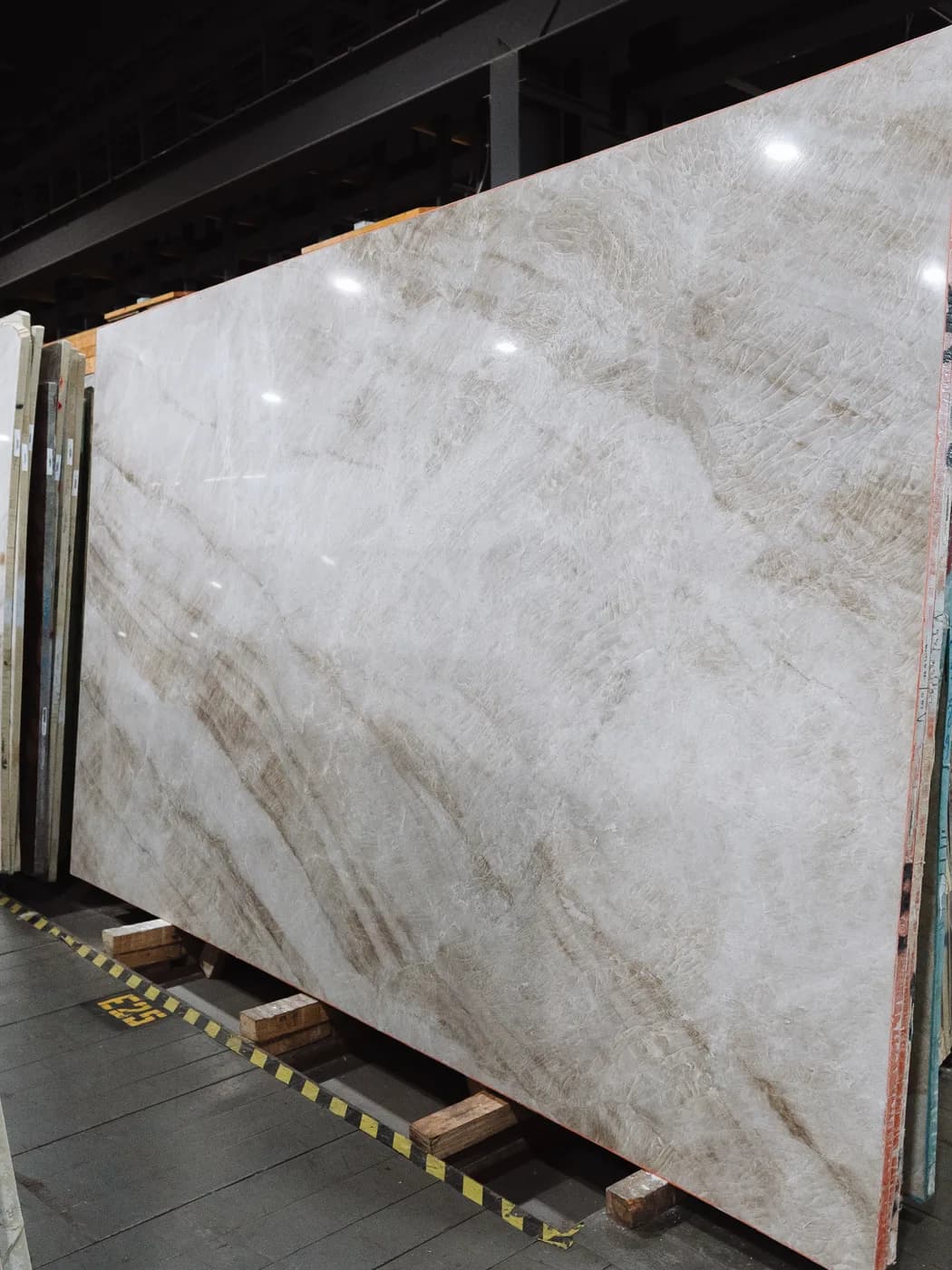 A soft taupe slab with quiet, diffuse movement