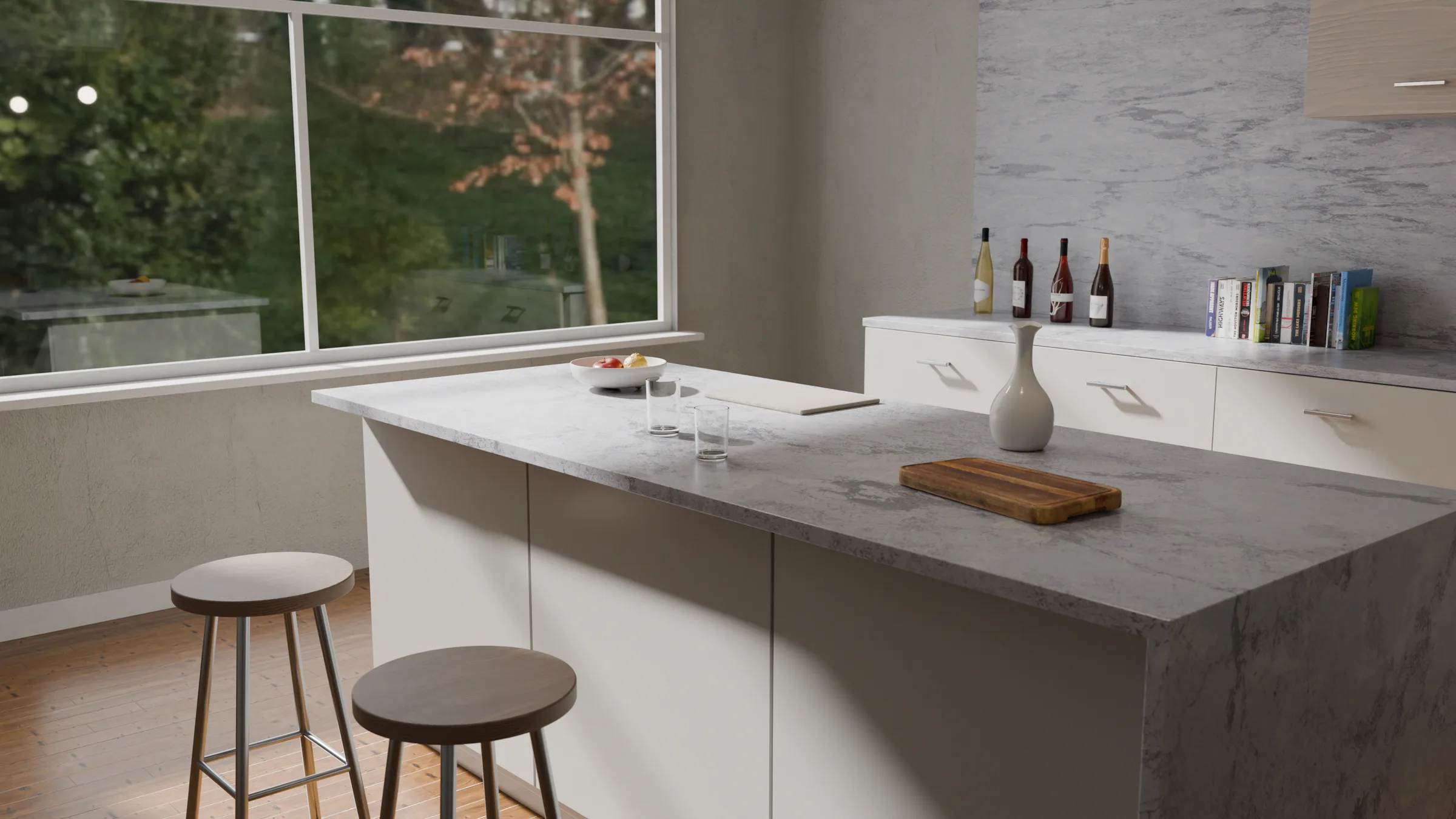 A kitchen island surfaced in honed grey marble, lit by a full-height window